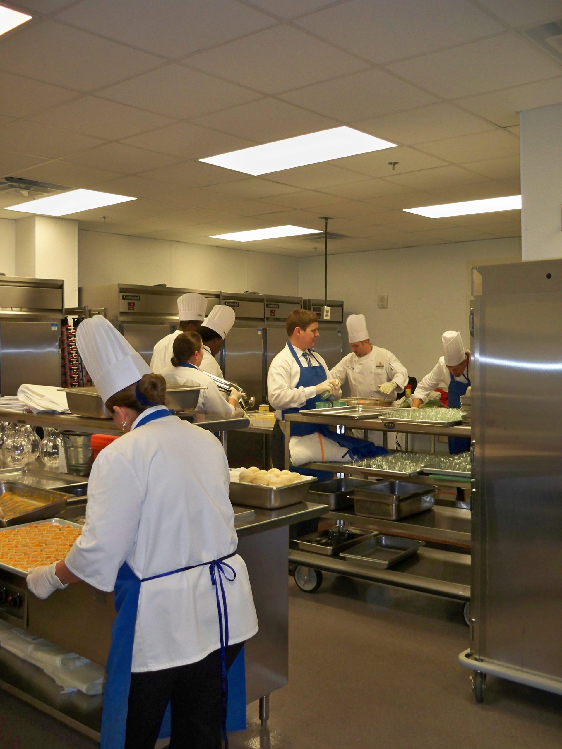 Caterer's working in kitchen